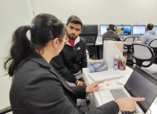 A senior tutor giving one-on-one help to a student at Target Language Academy