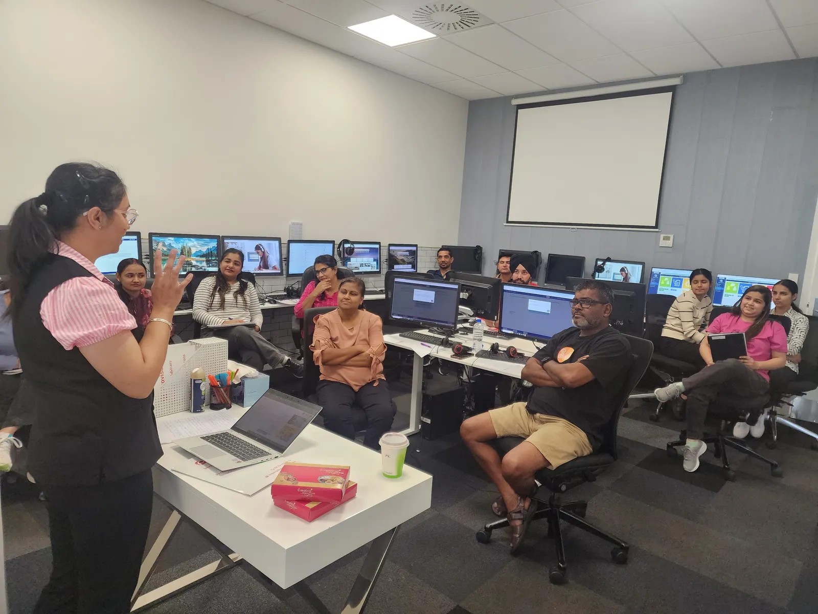 A Target Language Academy tutor teaching a PTE class in the Auckland computer lab